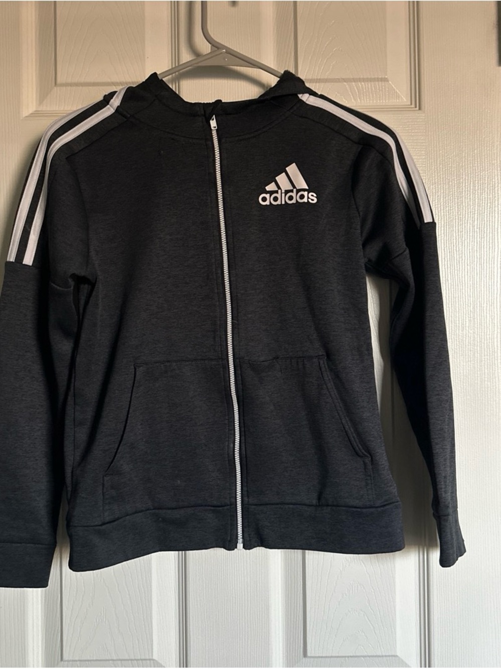 adidas Kids Black Zip Hoodie with White Stripes comes with matching sweatpants.